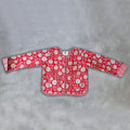 A red long-sleeve jacket by Colourstory with a white floral and circular pattern, laid flat on a textured grey background.