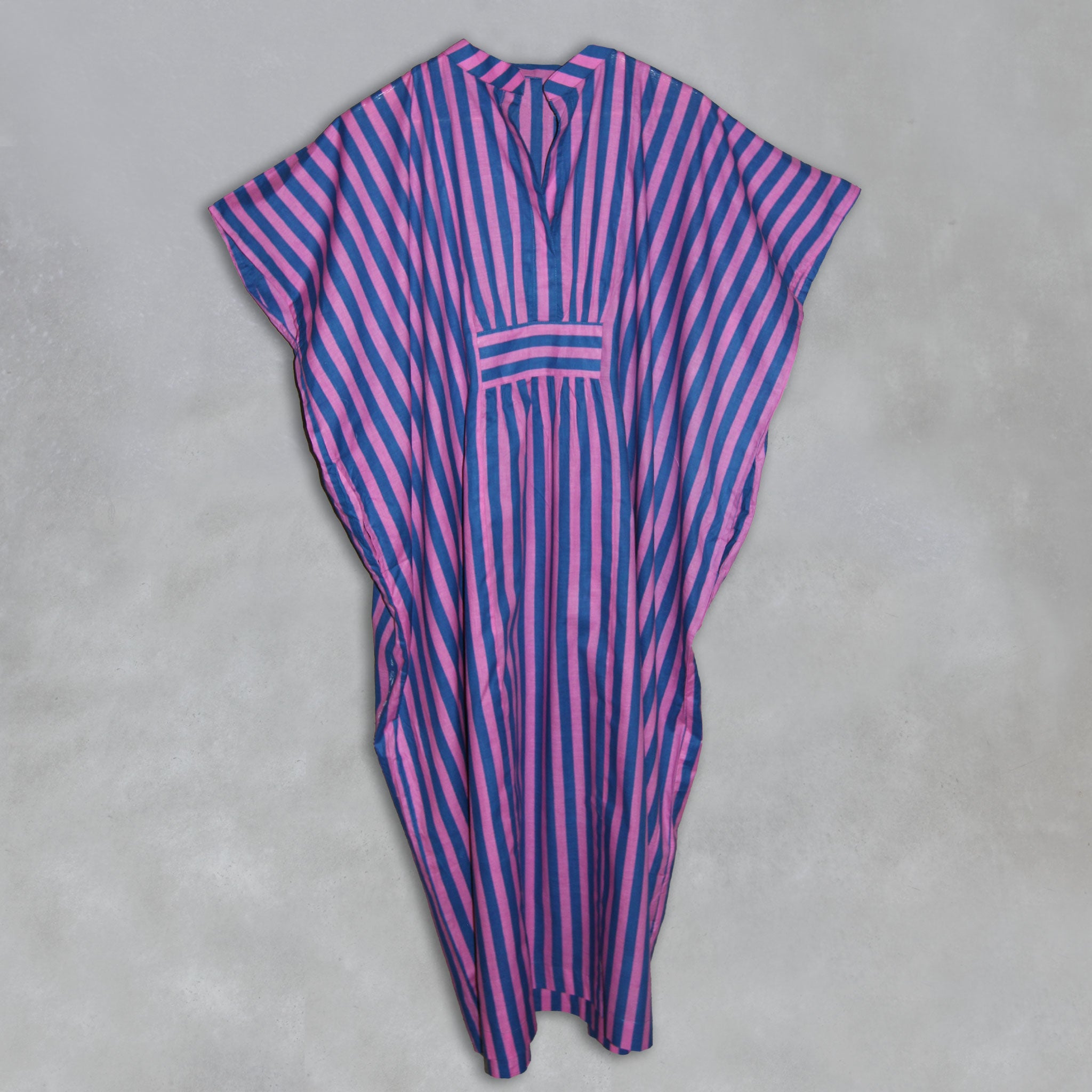 Pink and blue striped kaftan on a grey background
