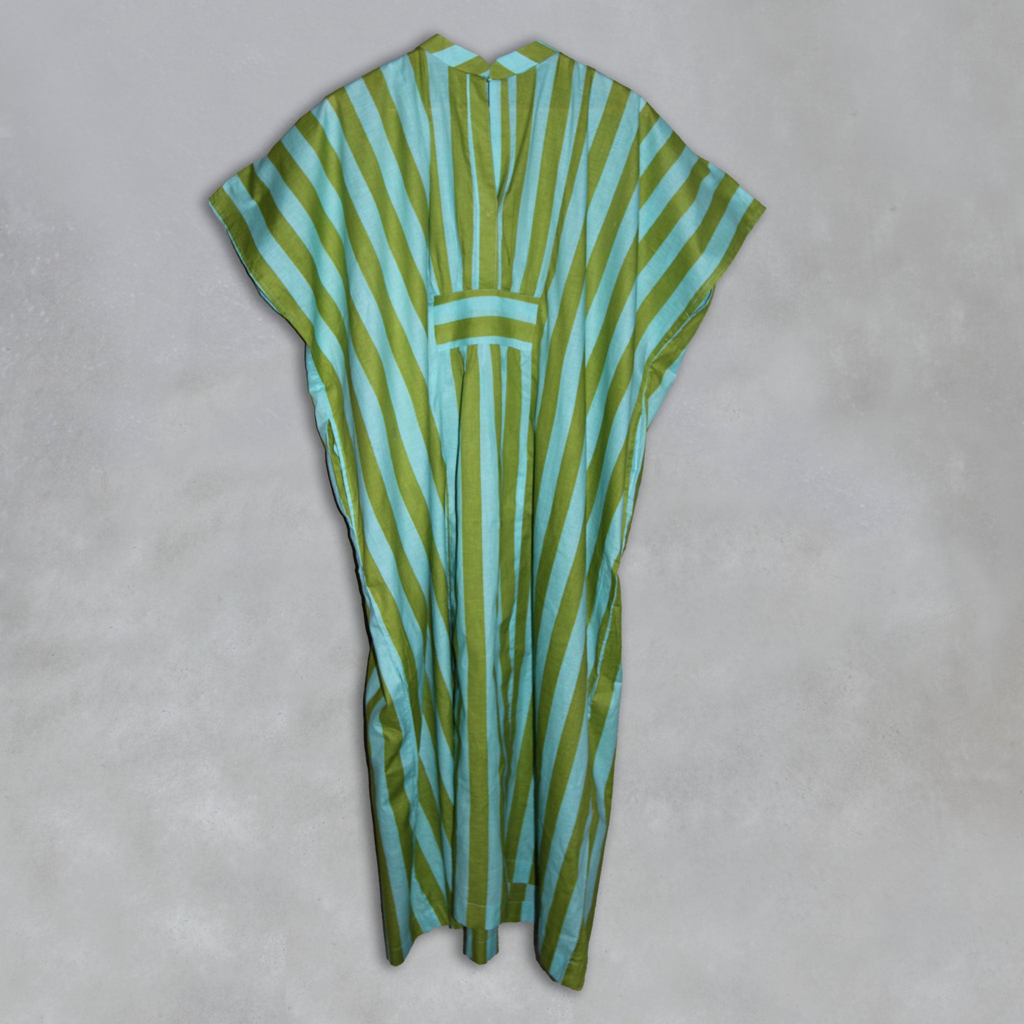 Green and teal striped kaftan on a grey background