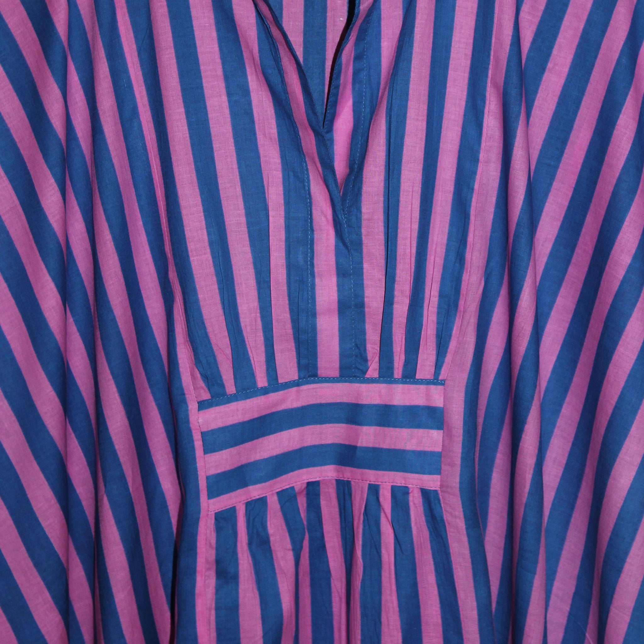 Close-up of a pink and blue striped Kaftan, detail of front rib detail