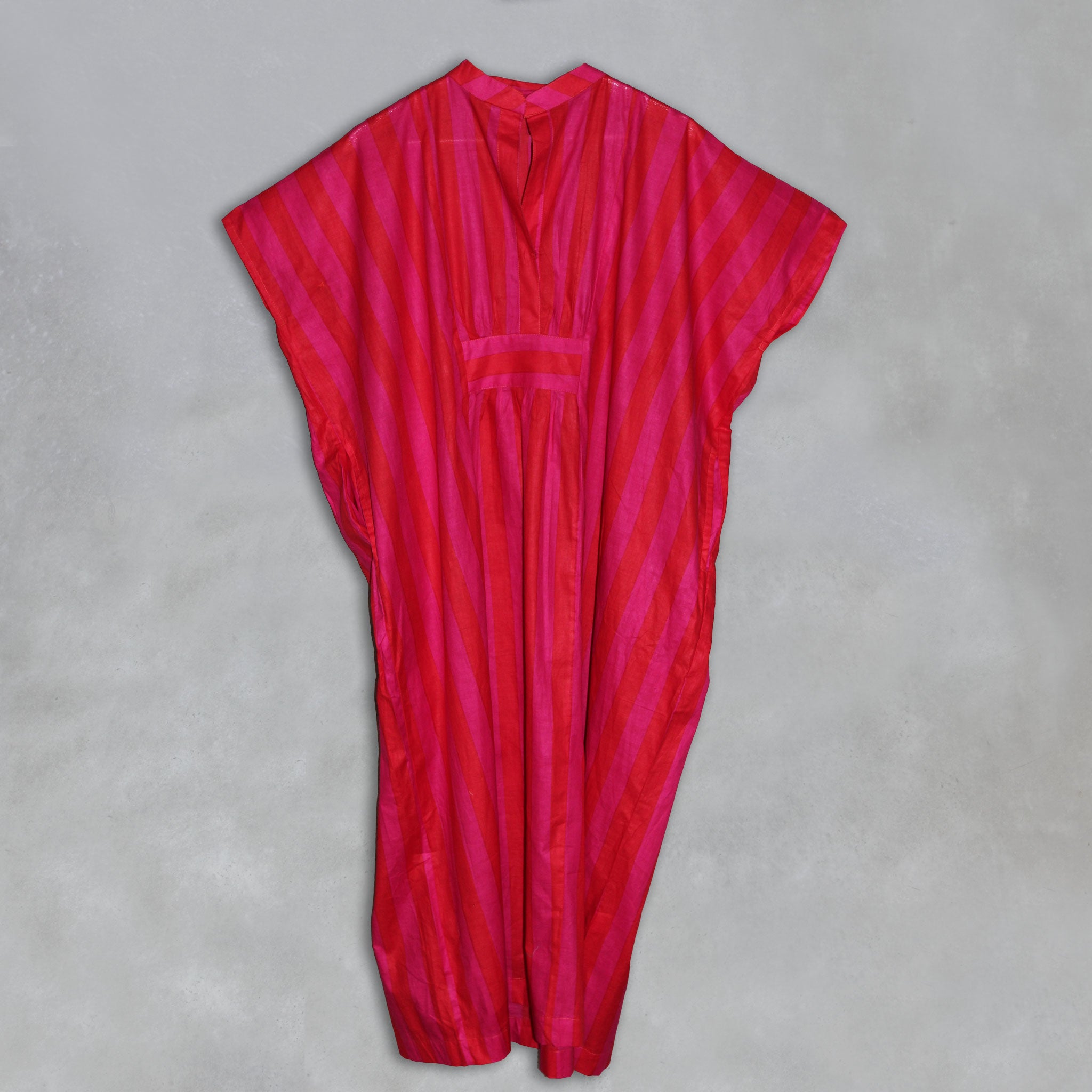Red and pink striped kaftan on a grey background