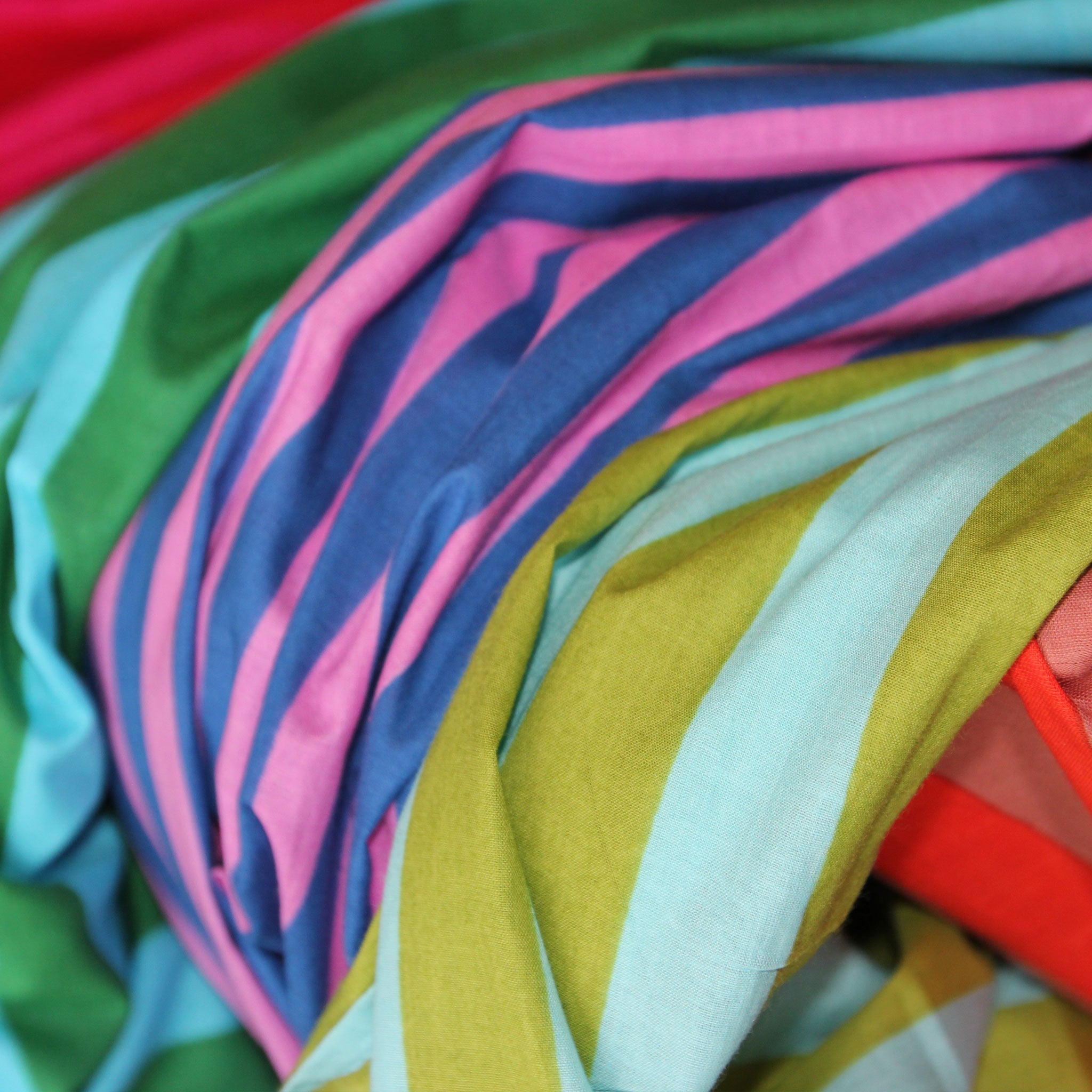 Close-up of colorful fabric with various stripes and colors.