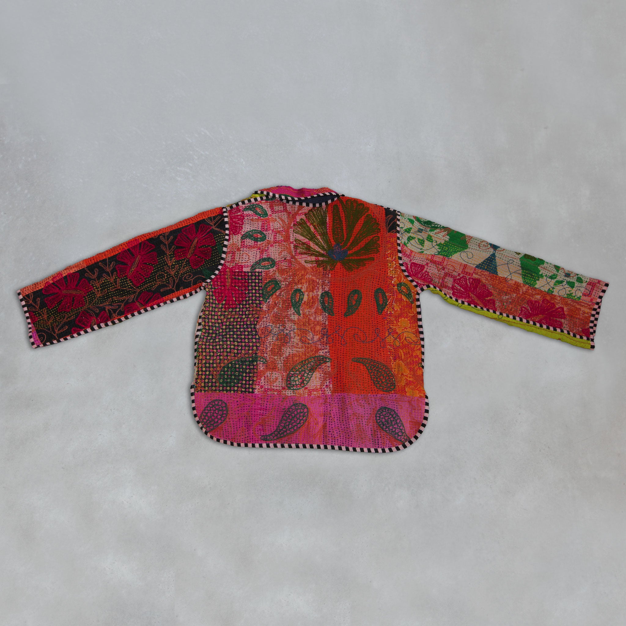 Colourful embroidered Kantha Jacket on a light grey background