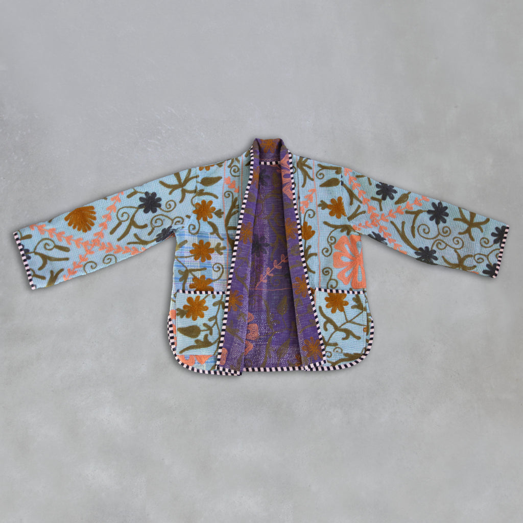 Colourful embroidered jacket on a grey background
