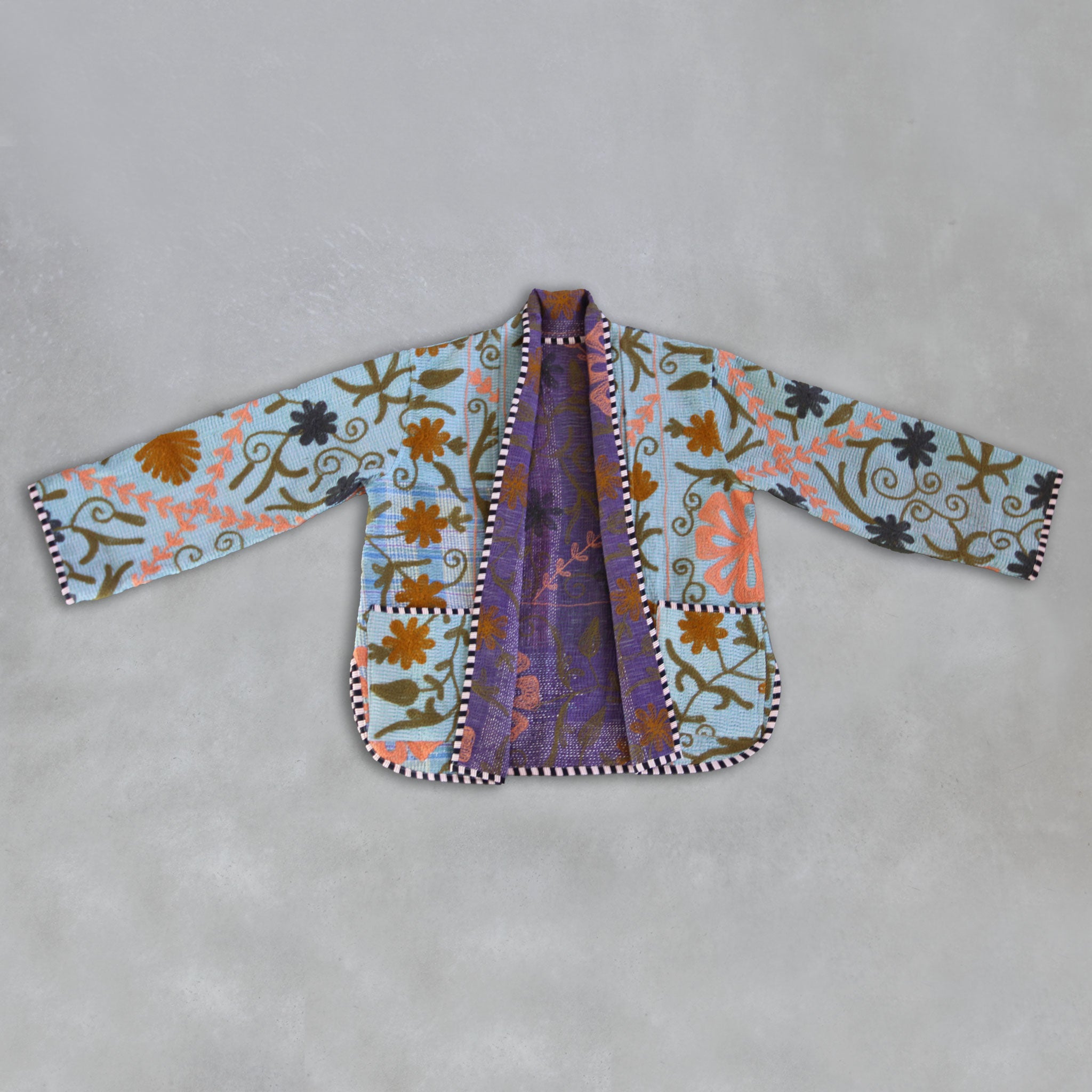 Colourful embroidered jacket on a grey background