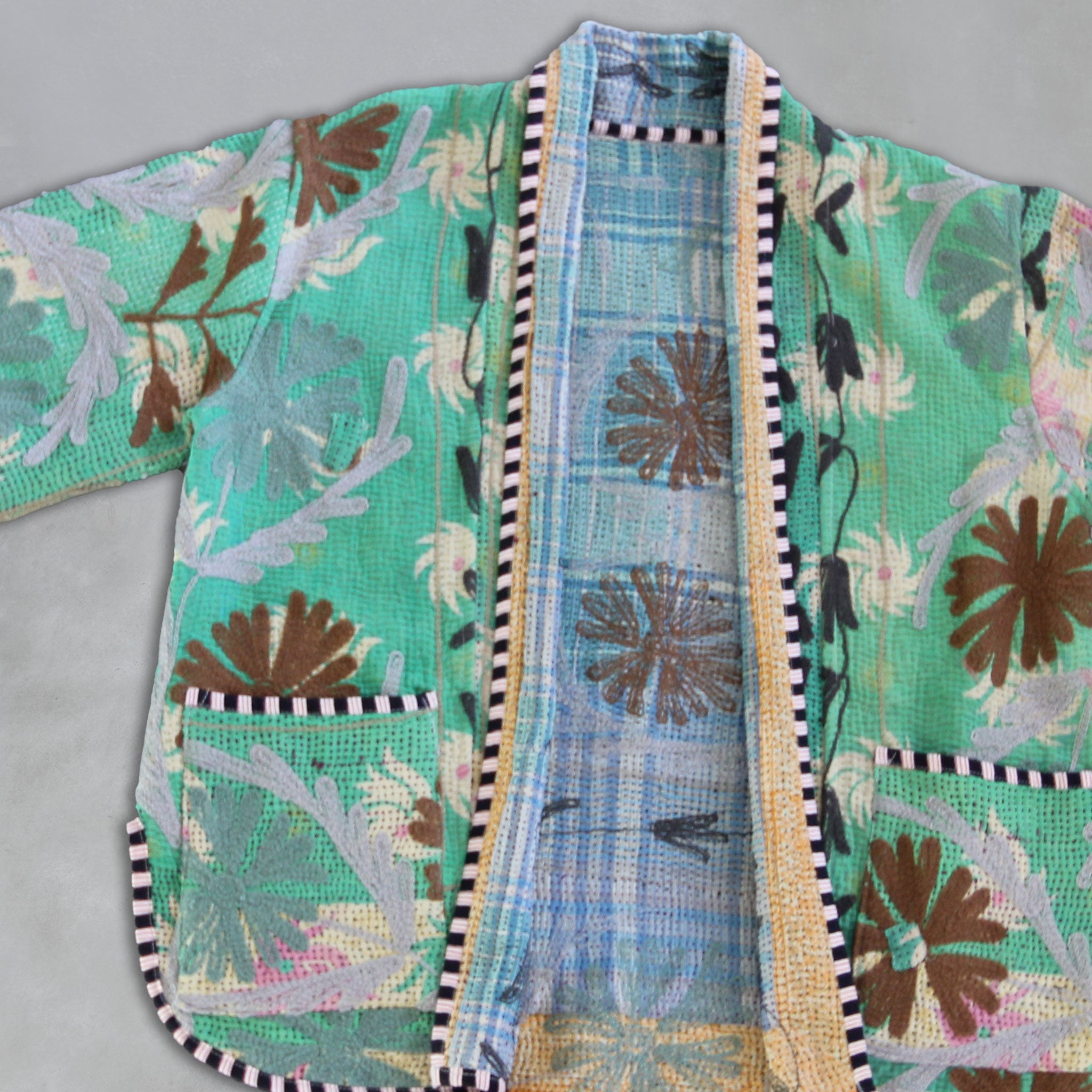 Mint floral-patterned Kantha Jacket  with a textured border on a grey background,by Colourstory