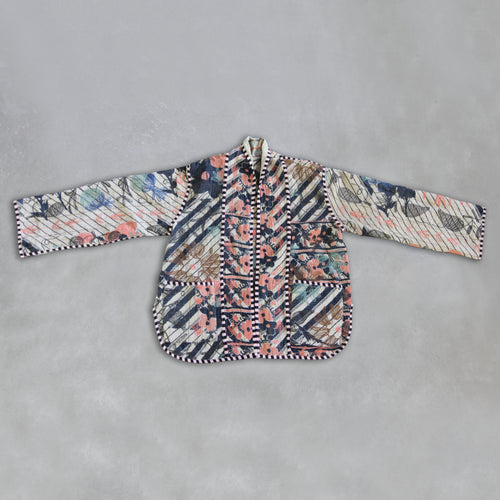 Colourful patterned Kantha jacket on a grey background