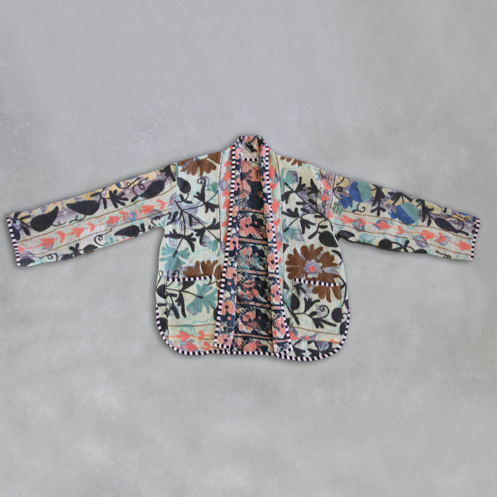 Floral patterned Kantha jacket on a grey background