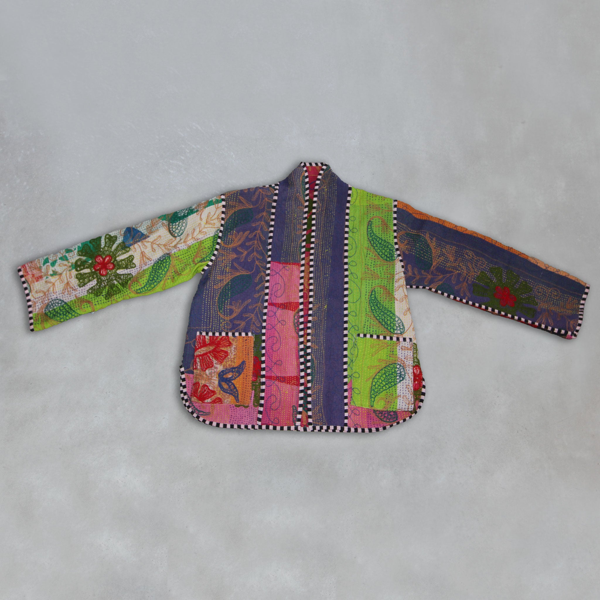 Colourful Kantha jacket on a grey background