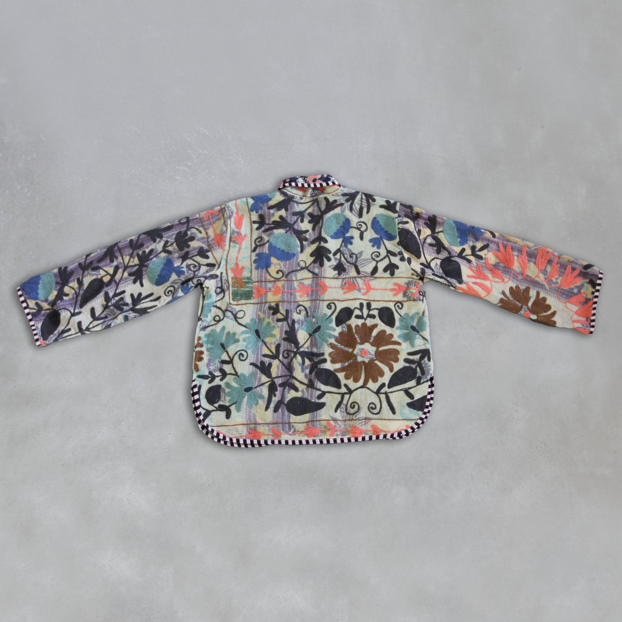 Colourful floral-patterned Kantha Jacket on a grey background