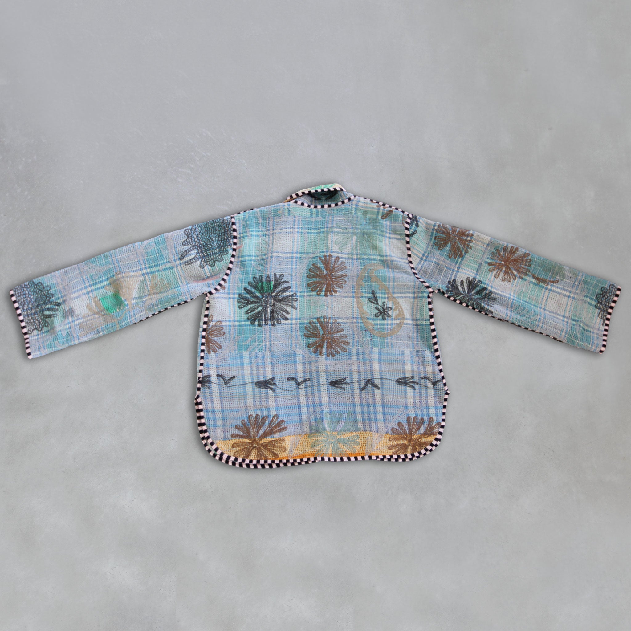Colourful patchwork Kantha Jacket on a grey background