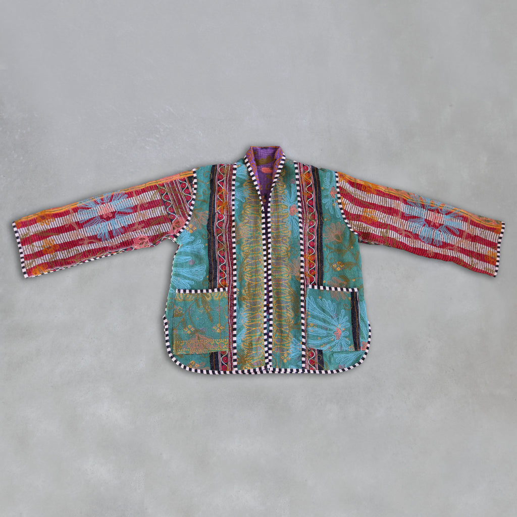 Colourful patchwork Kantha jacket on a grey background, by Colourstory.