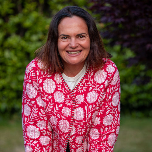 Woman (Tracey) wearing a red floral block print jacket outdoors